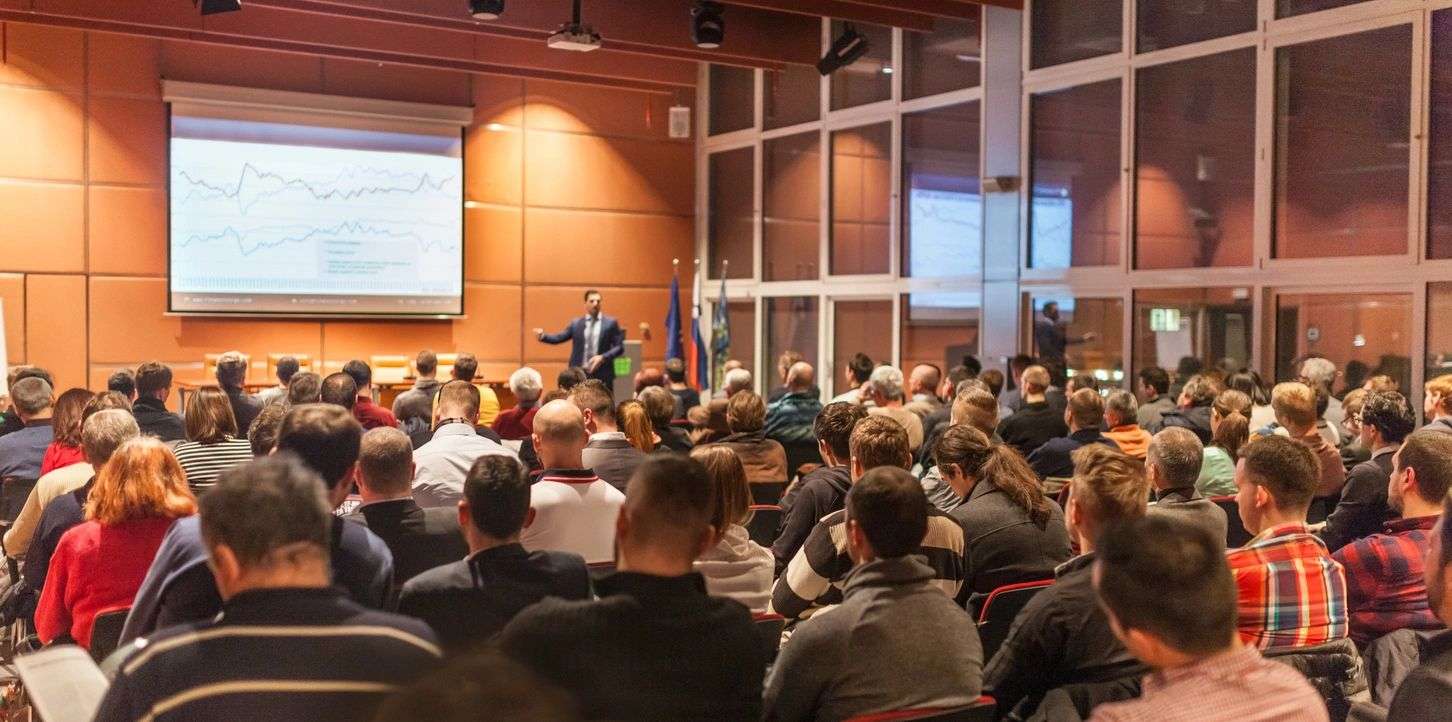 A professor is teaching many students in a classroom