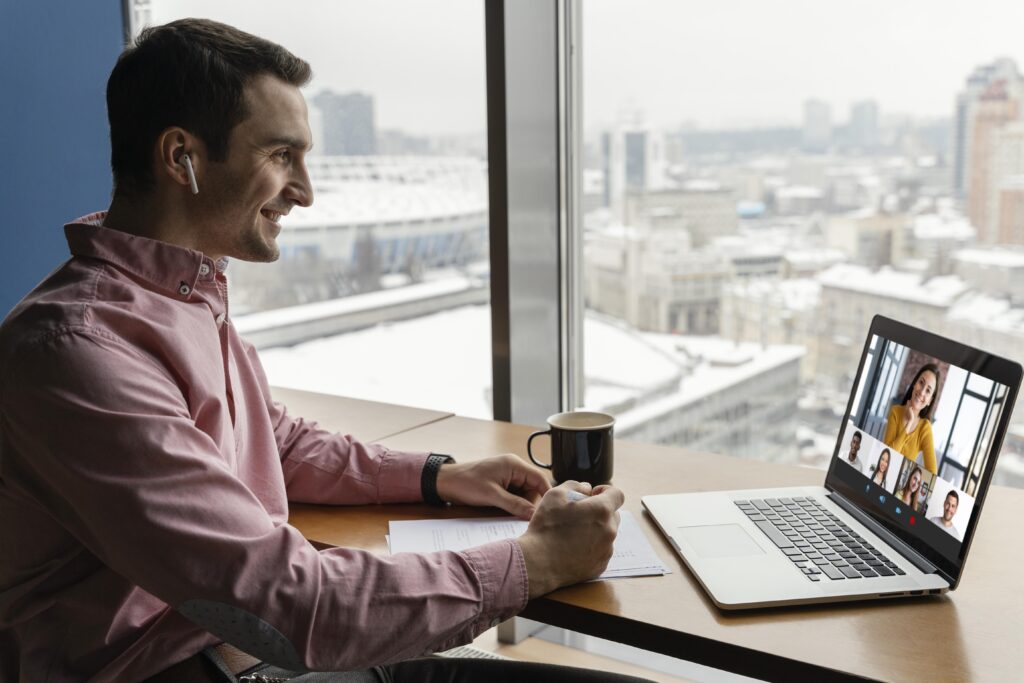 side view man having online video call with student