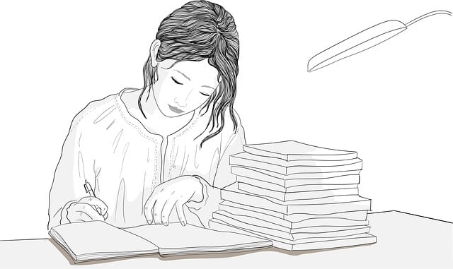 A woman writing in a notebook at a desk with a stack of books beside her