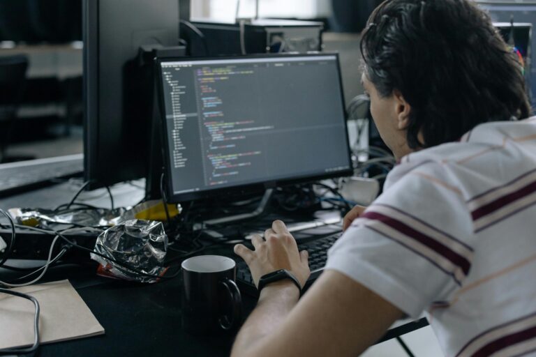 A boy is practicing coding in his computer.